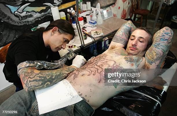 Man has a tattoo applied at the International Tattoo Convention at the Truman Brewary on October 6, 2007 in London, England.