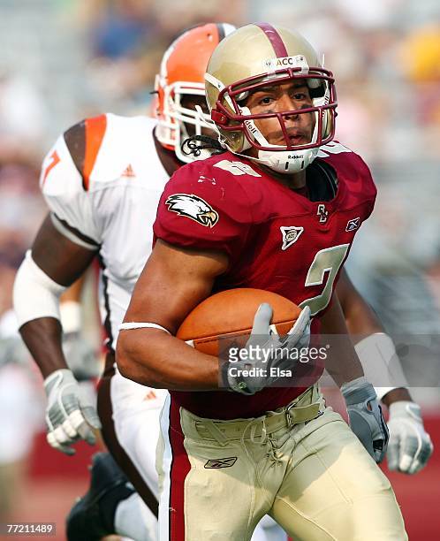 Brandon Robinson of the Boston College Eagles carries the ball in the fourth quarter as Freddie Barnes of the Bowling Green Falcons defends on...