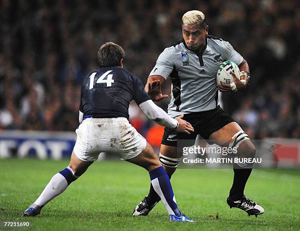 New Zealand's flanker Jerry Collins challenges France's winger Vincent Clerc during the rugby union World Cup quarter-final match New Zealand vs....