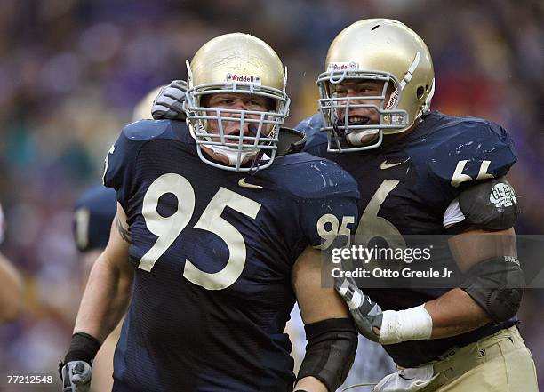 Jordan Reffett celebrates with Daniel Te'o-Nesheim of the Washington Huskies during the game against the USC Trojans at Husky Stadium on September...