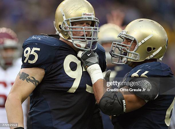 Jordan Reffett celebrates with Daniel Te'o-Nesheim of the Washington Huskies during the game against the USC Trojans at Husky Stadium on September...