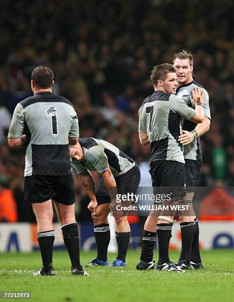 New Zealand's prop Tony Woodcock, centre Luke McAlister, flanker and captain Richie McCaw and lock Ali Williams look dejected at the end of the rugby...