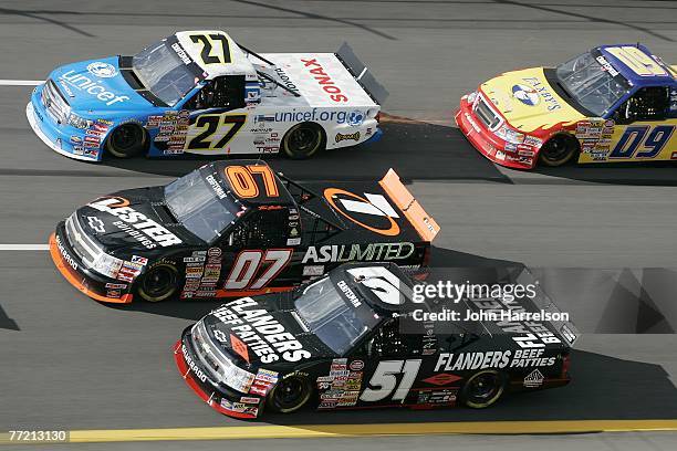 Kyle Busch , races driver of the Flanders Beef Patties Chevrolet, Tim Sauter, driver of the Lester Buildings/ASI Limited Chevrolet, and Jacques...