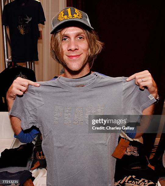 Musician Kyle Cook poses with the 'California Rising' clothing line at the Distinctive Assets Gift Lounge held during Andre Agassi's 12th Annual...