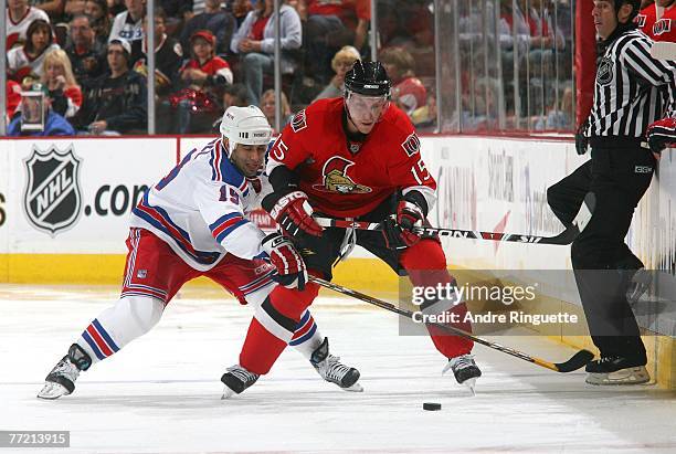Scott Gomez of the New York Rangers battles Dany Heatley of the Ottawa Senators at Scotiabank Place on October 6, 2007 in Ottawa, Ontario, Canada.