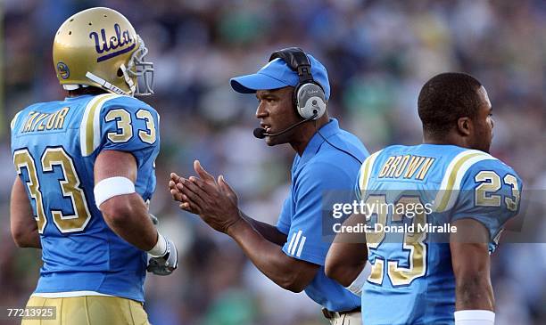 Head Coach Karl Dorrell of the UCLA Bruins encourages his players after a defensive stop against the Notre Dame Fighting Irish during their NCAA...