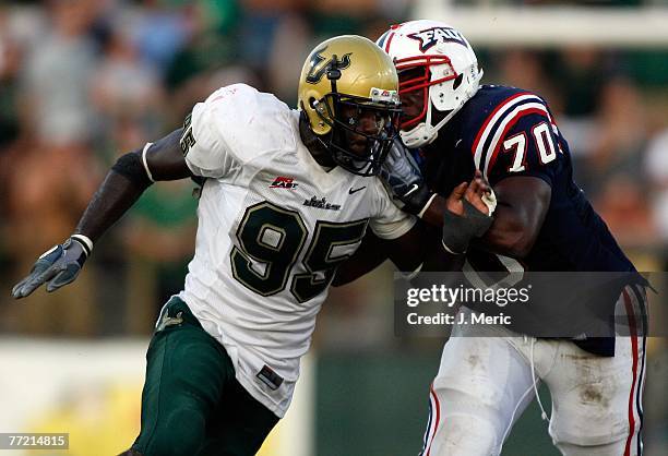 Defensive end George Selvie of the South Florida Bulls looks to get past offensive lineman Lavoris Williams of the Florida Atlantic Owls during the...