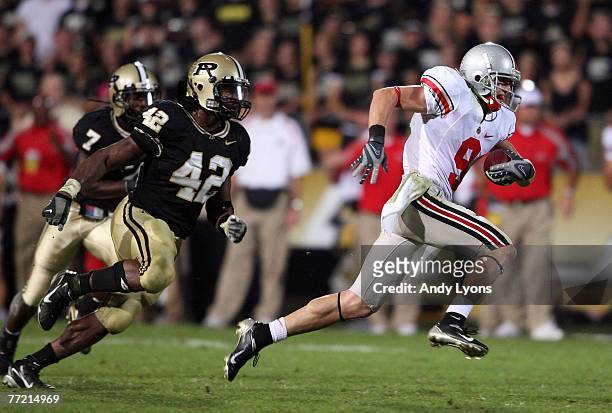 Brian Hartline of the Ohio State Buckeyes runs away from Anthony Heygood of the Purdue Boilermakers during the game on October 6, 2007 at Ross-Ade...