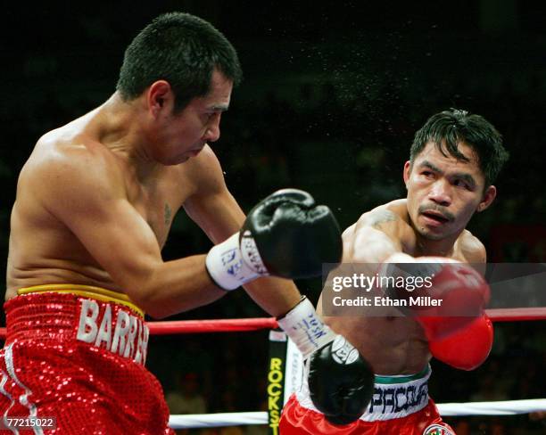 Marco Antonio Barrera and Manny Pacquiao trade punches in the fifth round of their 12-round super featherweight bout at the Mandalay Bay Events...