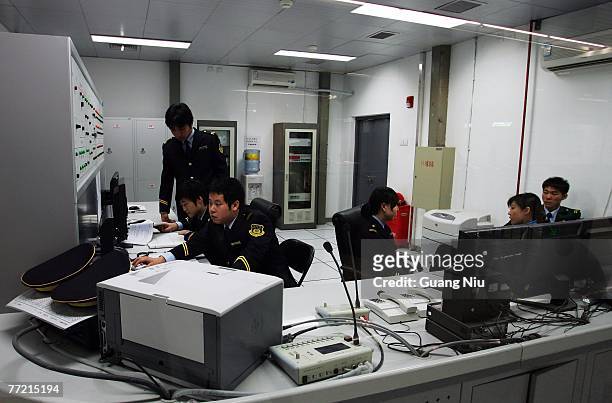 Staff work in an station office as the new No. 5 subway line goes into operation on October 7, 2007 in Beijing, China.The new line, which 27.6-km...