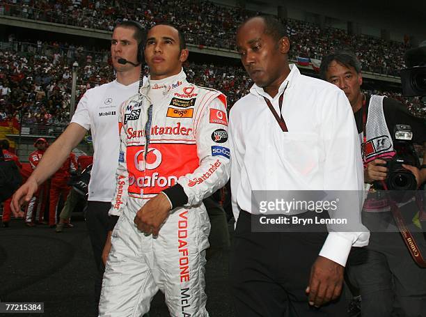 Lewis Hamilton of Great Britain and McLaren Mercedes walks with his father Anthony Hamilton before the Chinese Formula One Grand Prix at the Shanghai...