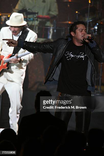 Musician Carlos Santana and vocalist Andy Vargas perform onstage at the Andre Agassi Charitable Foundation's 12th Annual Grand Slam for Children at...