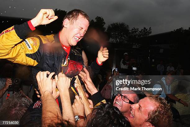 Sebastian Vettel of Germany and Scuderia Toro Rosso celebrates with team mates after finishing fourth in the Chinese Formula One Grand Prix at the...