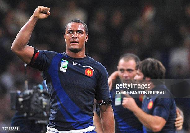 France's flanker Thierry Dusautoir, France's prop Olivier Milloud and France's winger Christophe Dominici celebrate at the end of the rugby union...