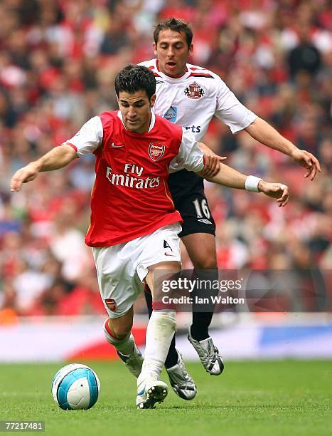 Michael Chopra of Sunderland tries to tackle Cesc Fabregas of Arsenal during the Barclays Premier League match between Arsenal and Sunderland at the...