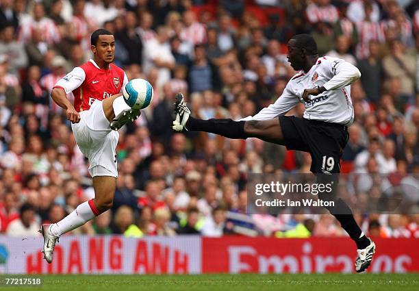 Dwight Yorke of Sunderland and Theo Walcott of Arsenal in action during the Barclays Premier League match between Arsenal and Sunderland at the...