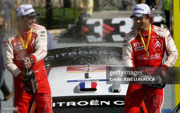 French rally driver Sebastien Loeb and co-driver Daniel Elena celebrate on the podium after winning the 43th Rally of Catalunya , in Salou, near...