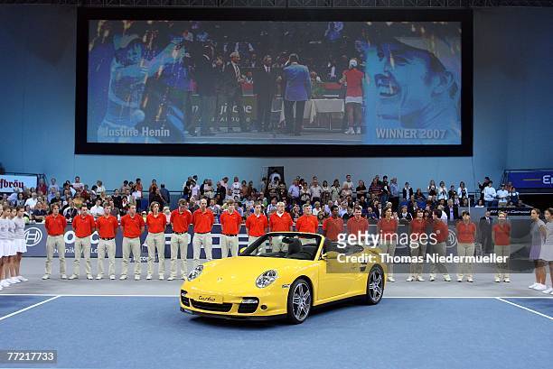 Yellow Porsche Carrera is seen after the match between Justine Henin of Belgium and Tatiana Golovin of France at the Porsche Tennis Grand Prix at the...