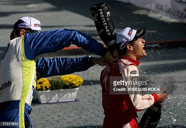 Finnish Marcus Gronholm pours cava inside Spanish rally driver Daniel Sordo's shirt on the podium during the 43rd Rally of Catalunya , in Salou, near...