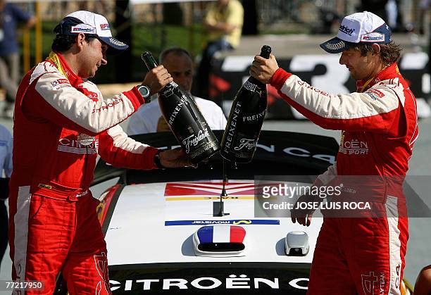 French rally driver Sebastien Loeb and co-driver Daniel Elena celebrate on the podium after winning the 43rd Rally of Catalunya , in Salou, near...