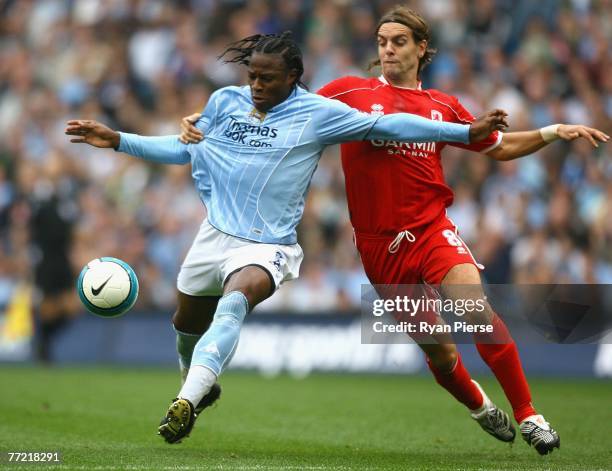 Emile Mpenza of Manchester City is tackled by Jonathan Woodgate of Middlesbrough during the Barclays Premier League match between Manchester City and...