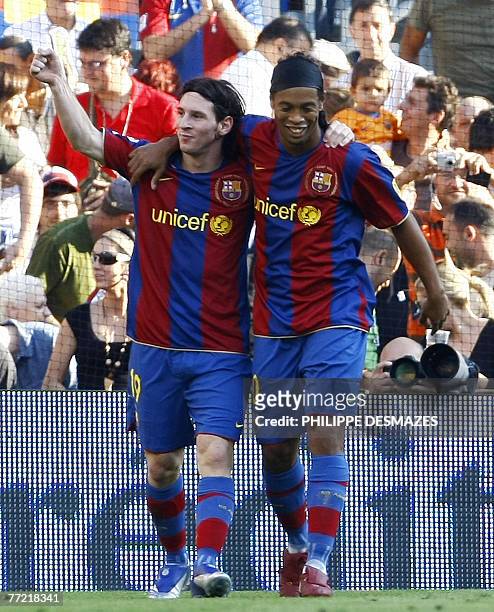 Barcelona's Argentinian Messi is congratulated by his teammate Brazilian Ronaldinho after scoring during the Liga football match Barcelona vs...