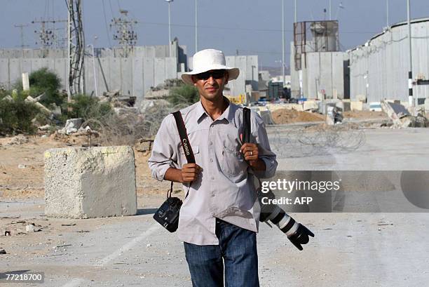 Gaza Strip-based AFP photographer Mahmud Hams looks on as the Erez crossing between Israel and northern Gaza Strip appears behind him, 31 July 2007....