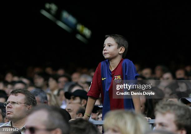 Young Barcelona supporter watches his side beat Atletico de Madrid during the Primera Liga match between Barcelona and Atletico de Madrid at the Camp...