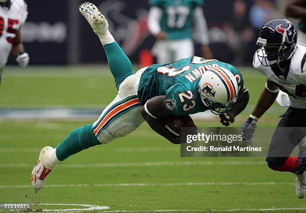 Running back Ronnie Brown of the Miami Dolphins dives for yardage against Von Hutchins of the Houston Texans at Reliant Stadium on October 7, 2007 in...