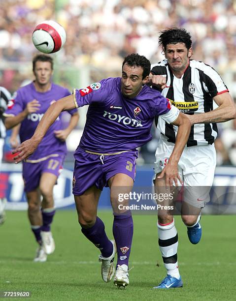 Dario Dainelli of Fiorentina in action against Vincenzo Iaquinta of Juventus during the Serie A match between Fiorentina and Juventus at the Stadio...