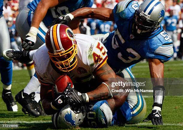 Running back Mike Sellers of the Washington Redskins runs over Detroit Lions linebacker Ernie Sims to score a touchdown as Detroit linebacker Paris...