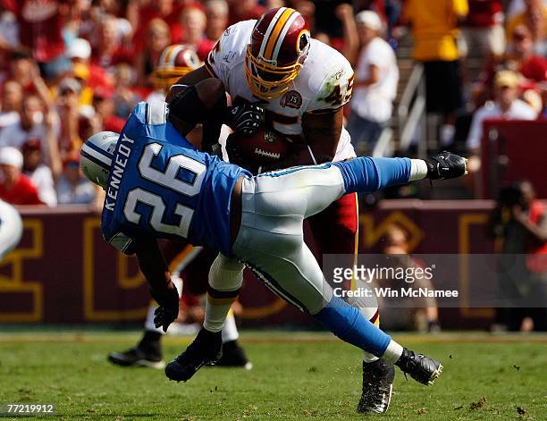 Running back Mike Sellers of the Washington Redskins runs over Detroit Lions safety Kenoy Kennedy in second quarter action at FedEx Field October 7,...