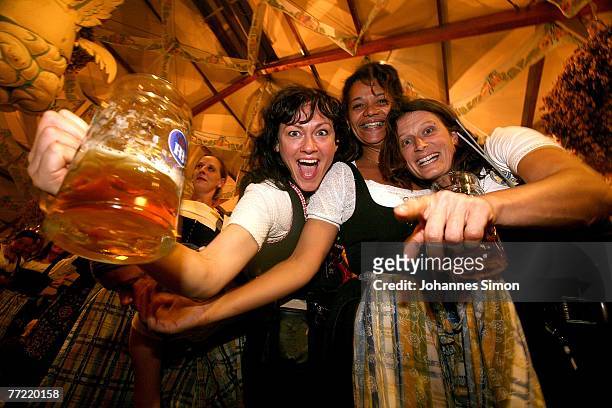 Waitresses celebrate the last evening of the Oktoberfest beer festival dancing on tables of the Hofbraeuhaus beer tent on October 7, 2007 in Munich,...