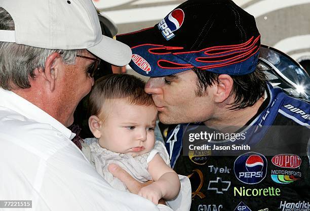 Jeff Gordon, driver of the Dupont/Pepsi Chevrolet, kisses his daughter Ella Sophia, in victory lane, following his win of the NASCAR Nextel Cup...