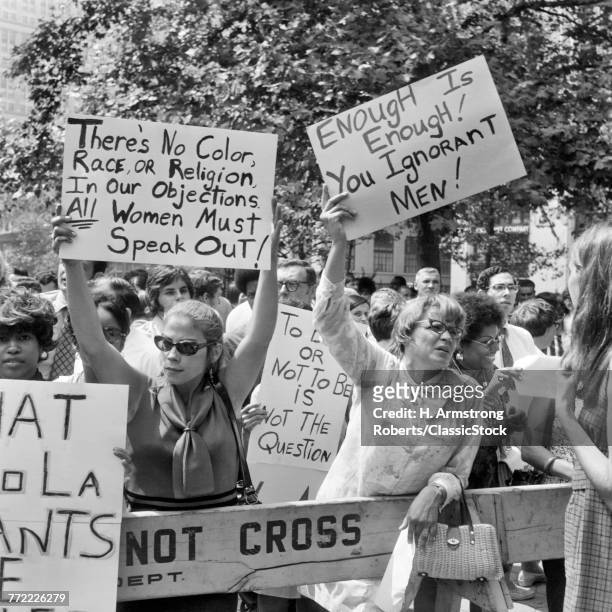1970s GROUP OF WOMEN DEMONSTRATING WITH WOMENS LIBERATION SLOGAN PLACARDS IN NYC USA