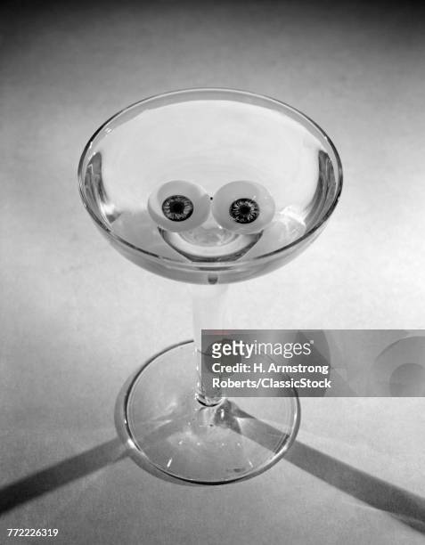 1950s HAPPY HOUR MARTINI GLASS WITH OLIVES & RIND LEMON POSITIONED TO LOOK LIKE A SMILEY FACE
