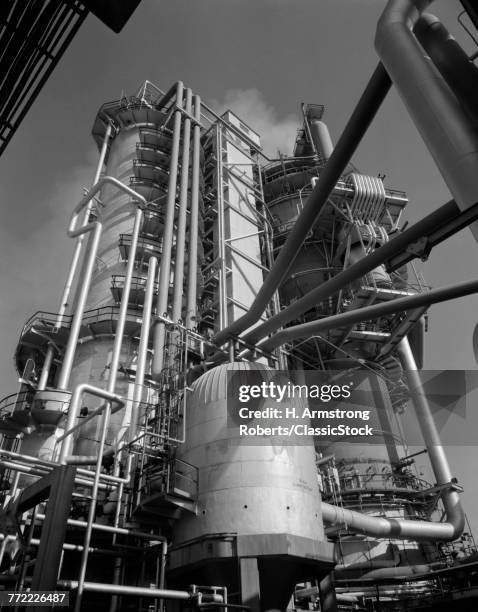 1960s LARGE REFRACTING TOWERS AT OIL REFINERY