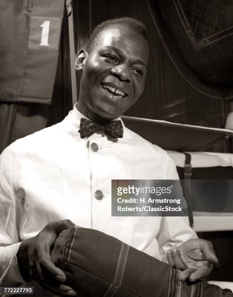1920s 1930s 1940s SMILING AFRICAN AMERICAN MAN PORTER ON PULLMAN CAR ON PASSENGER RAILROAD TRAIN OVER NIGHT SLEEPING CAR