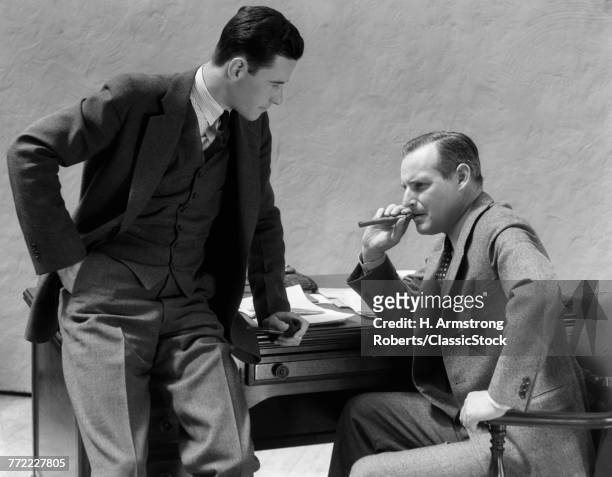 1930s TWO MEN AT DESK TALKING ONE MAN SMOKING CIGAR