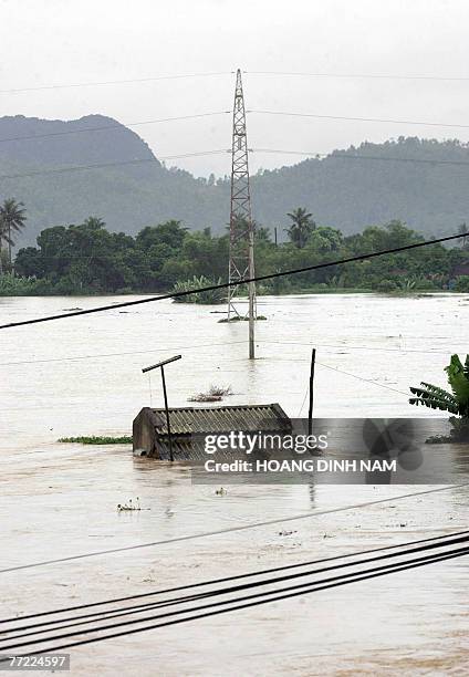 Flooded house is seen on the banks of the Ma river in the central province of Thanh Hoa, 05 October 2007, after Typhoon Lekima hit the central part...