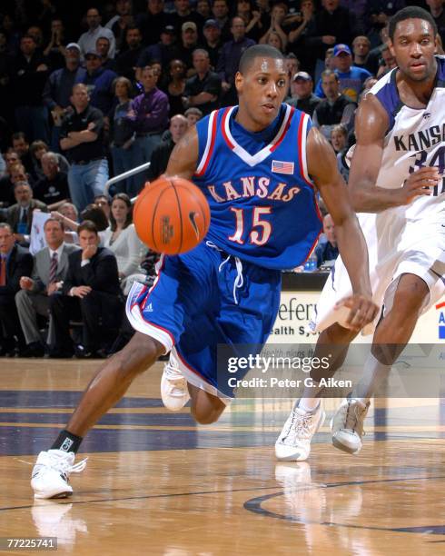 Kansas guard Mario Chalmers drives past Kansas State guard Akeem Wright in the first half at Bramlage Coliseum in Manhattan, Kansas, February 19,...