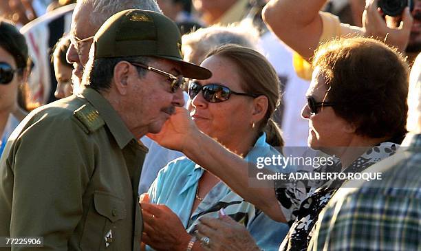 Cuba's interim president Raul Castro greets the widow of revolutionary leader Ernesto 'Che' Guevara, Aleida March, during the official ceremony to...