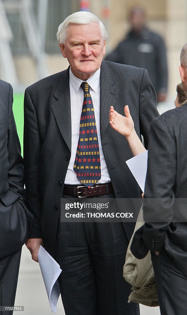 High Court judge, Scott Baker (C) talks