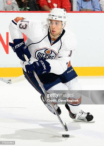 Andrew Cogliano of the Edmonton Oilers turns and skates with the puck during the game between the Edmonton Oilers and Detroit Red Wings on October 8,...