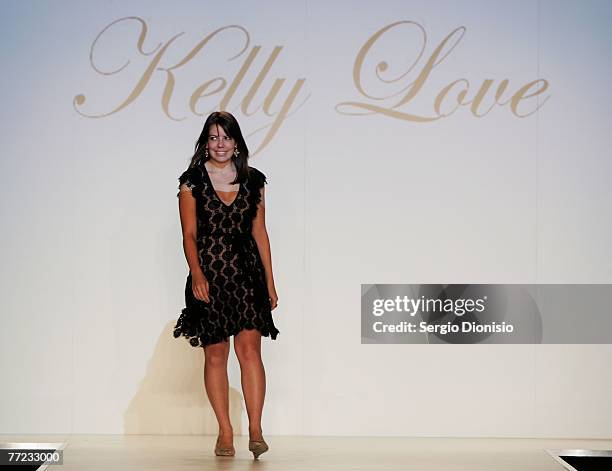 Designer Kelly Love of the label Kelly Love acknowledges the audience following her catwalk collection show as part of the New Generation Catwalk...