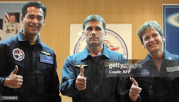 Members of an International space crew Sheikh Muszaphar Shukor of Malaysia, Yury Malenchenko of Russia and Peggy Whitson of the United States pose...