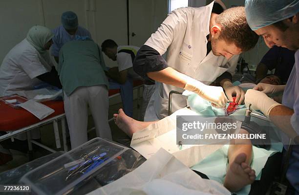 Algerian doctors circumcise children during a mass circumcision at a local hospital in Algiers City 09 October 2007. The Muslim religion stresses...