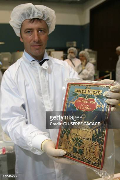 Italian ESA astronaut Roberto Vittorio holds one copy of Jules Verne's book "De la Terre a la Lune" ready to be packed to go on the space with the...