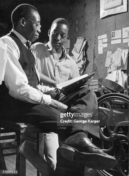 Two models reneact a situation from the book 'Black Boy,' an autobiographical account of the youth of American author Richard Wright, 1945. This...