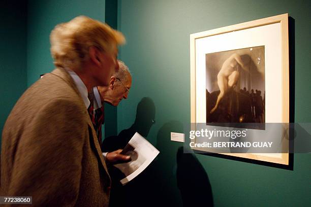 Visitors looks at a photograph called "In Memoriam" during an exhibition dedicated to US fashion photographer, war reporter and portraitist Edward...